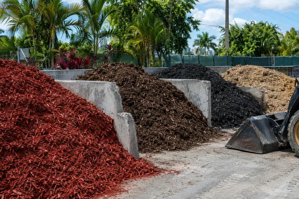 Bulk red, brown, black and cypress mulch bins at a landscape supply yard