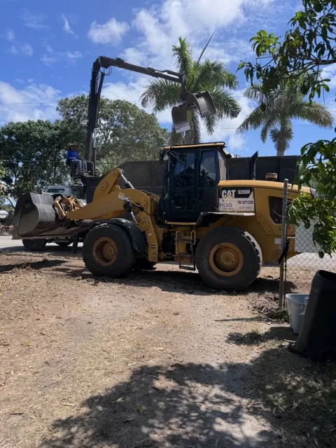 Before: RGS loader and grapple truck clearing an overgrown residential lot
